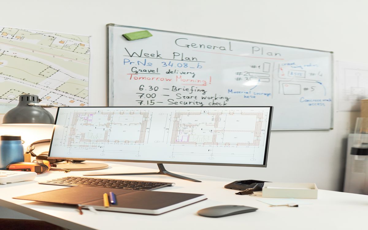 Collaborative workspace with whiteboards showing curriculum planning diagrams