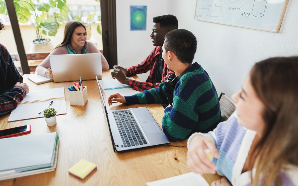 Students working on laptops during a project-based CS session